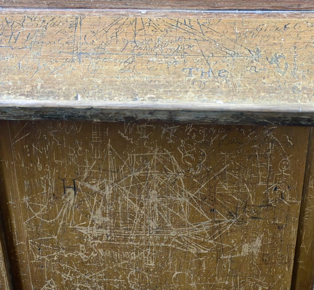 1. Cornworthy. Bench panel. Gaff-rigged sailing ship and other ship on bookrest above. Photo K.  Scott.