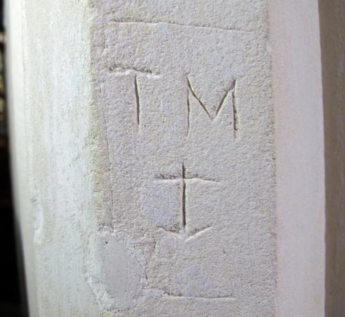 2. Framed initials T M, with anchor. South aisle pier.