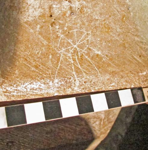 10.  Asterisk type symbol. North aisle pier base. 