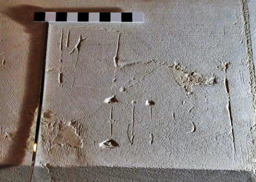 11. Letters within frame. West wall capital.