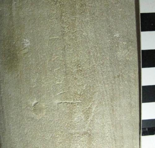 4. Illegible word on its side. Traces of limewash within letters. North aisle pier.