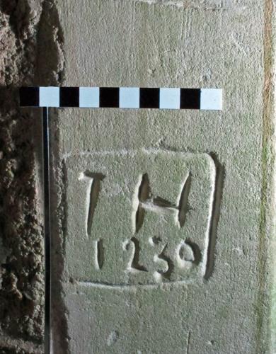 4.  Assumed initials I H & date 1230.  ?Reference to founding of church. South doorway. 