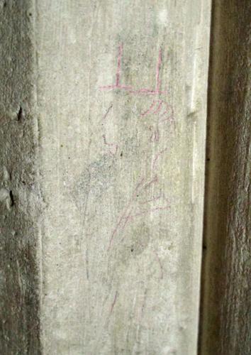 7. Figure with tall hat, facing left. Highlighted. North aisle pier.