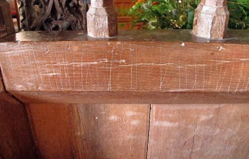 7. Series of vertical score marks. Rood screen.