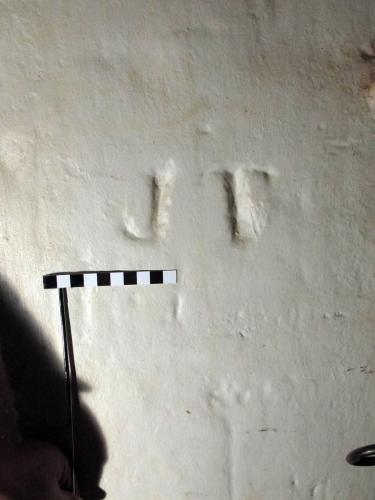 7. Initials J F or J T. West doorway.