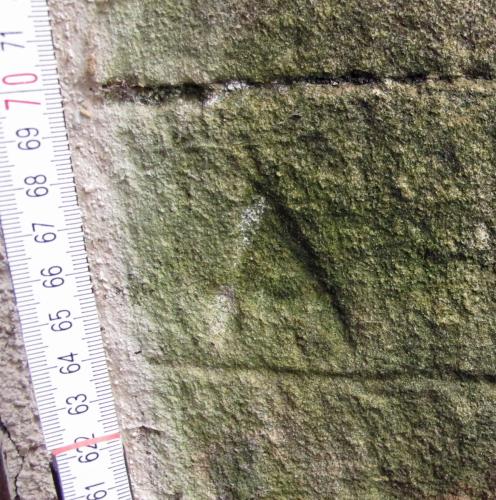 7. Deeply carved letter A, underlined. External tower doorway.