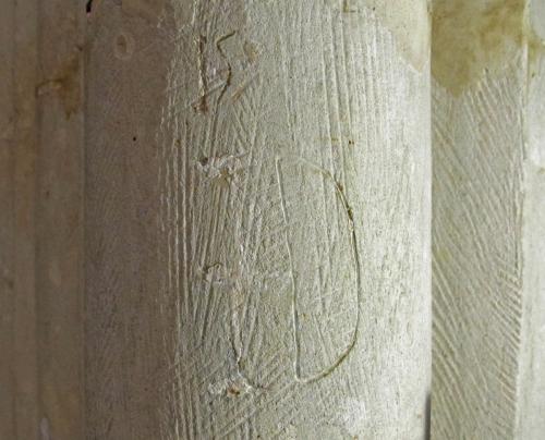 9. S. aisle pier. Letter I (crossed) or J, with remnants of limewash,  and D.