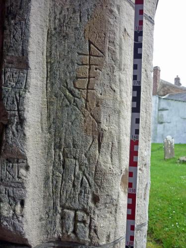 Bondleigh 1. Porch. From top downwards, date 1606 (feint); merchants' mark; ?dagger; several probable initials.