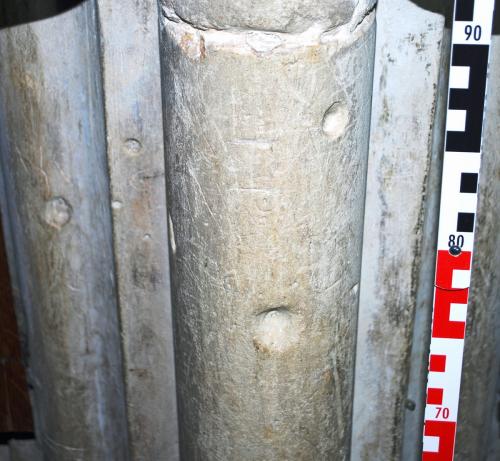 2. Multiple marks including letters, conical holes, & small circles. Nave pier.