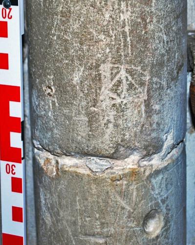 3. Unidentified ?symbol, conical holes other marks. Nave pier.