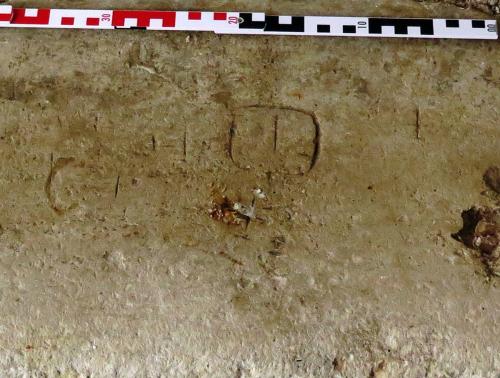 7. Multiple marks, including unidentified ?symbol. Porch, west bench. 