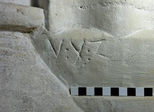 4. Deeply cut letters V X Z. North arcade pier base.