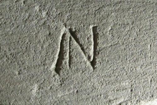 4. Letter ?N on the shield of the north-eastern effigy.