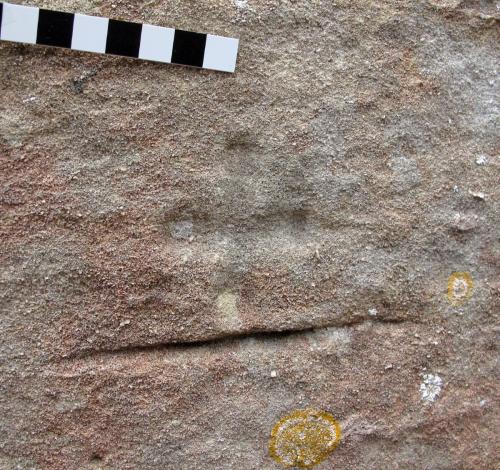 2. Cross, underlined by a deep score mark. Exterior NE corner.